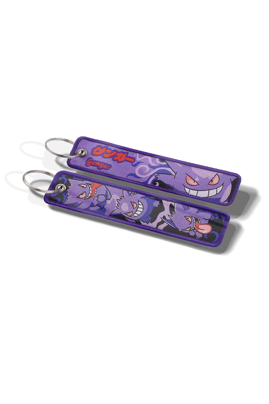 Two purple keychains with cartoon character designs on a white background