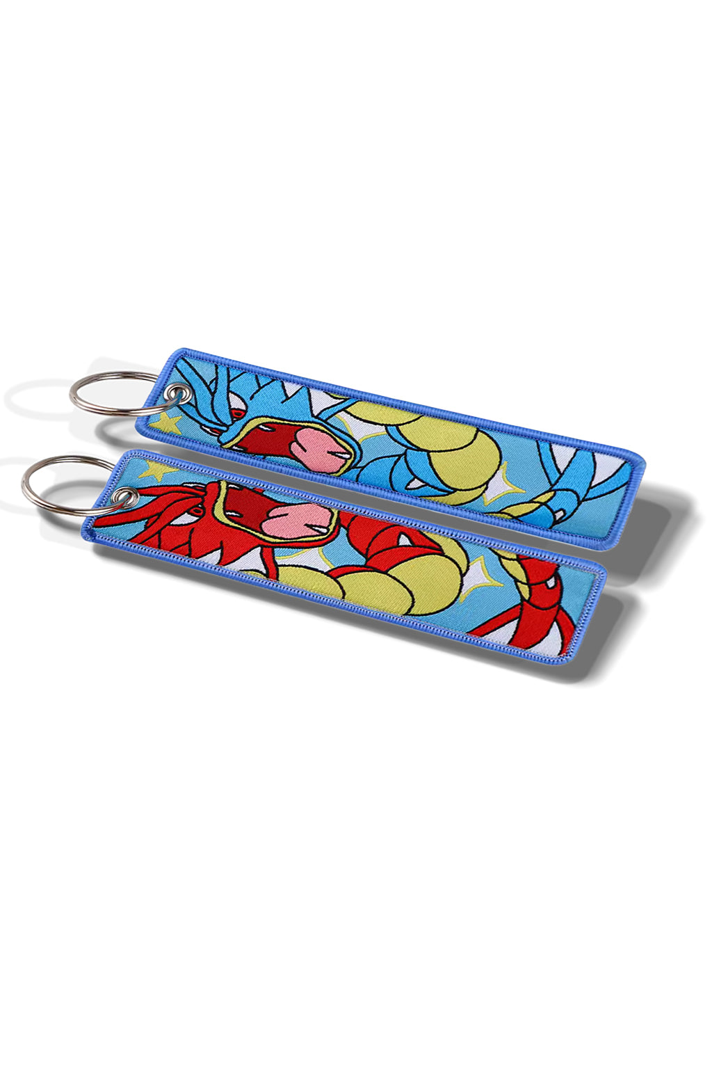 Keychain with cartoon design attached to a car key on a blue fabric background