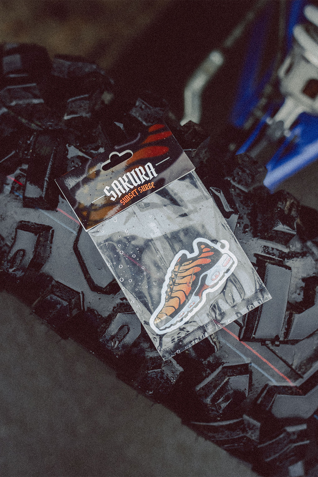 Sakura TN Air Freshener placed on some offroad tyres