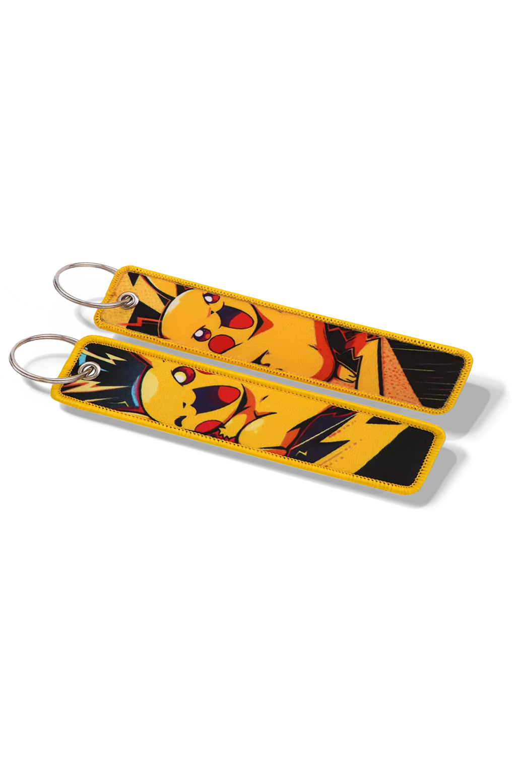 Keychain with a Pika character attached to a car key on a tartan fabric surface inside a vehicle.