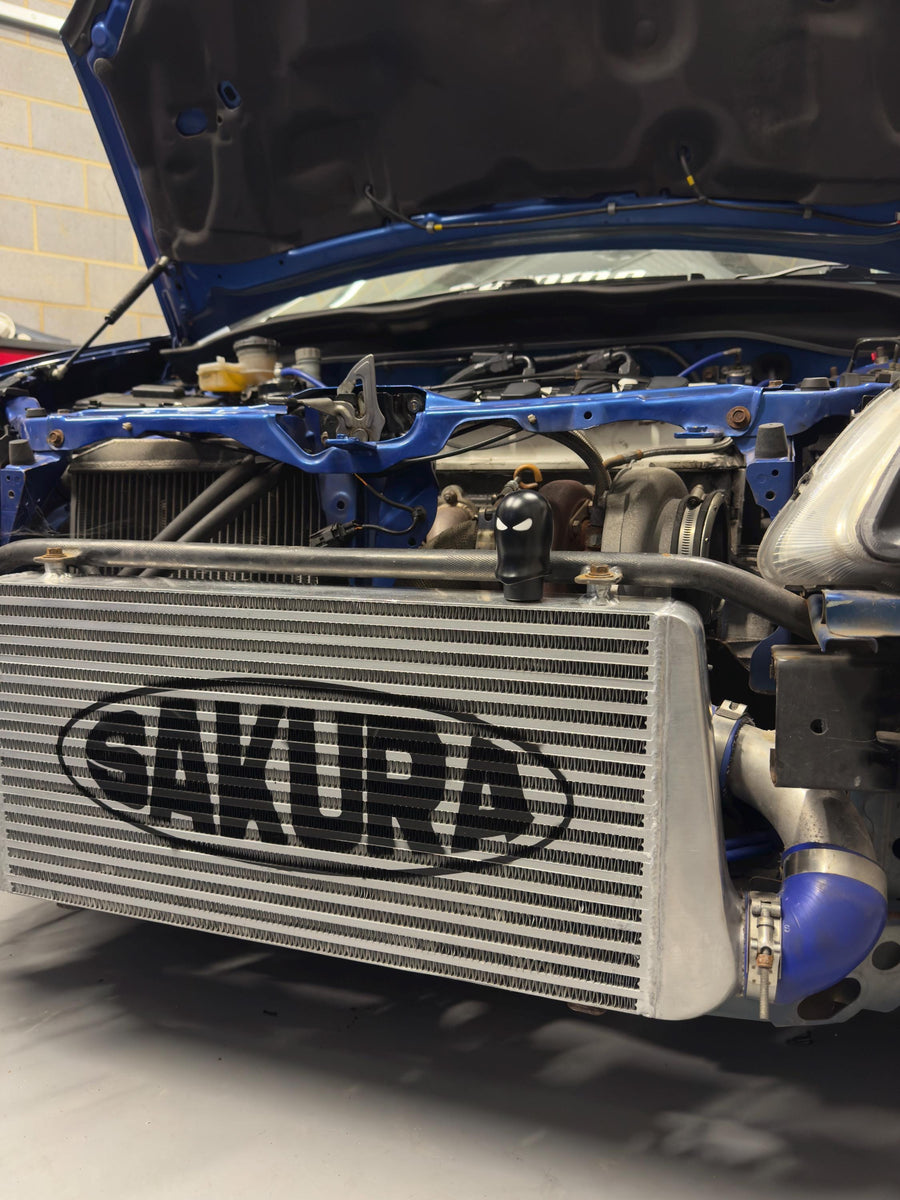 Car engine with Sakura intercooler in a garage setting