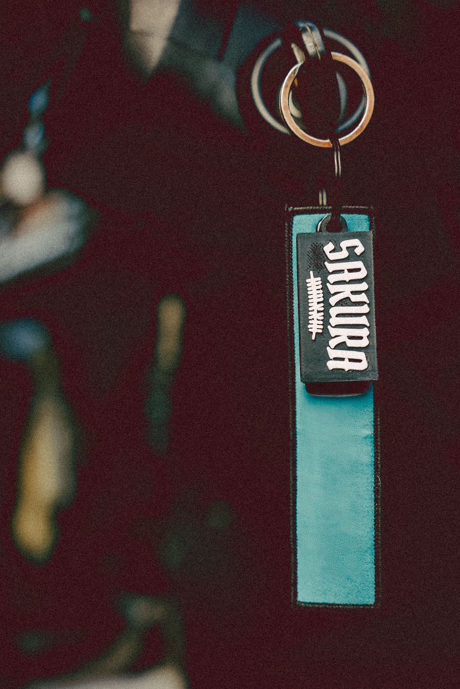 sakura key chain hanging on some keys