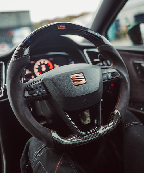 Vertical image showing carbon LED performance steering wheel by Sakura Streets