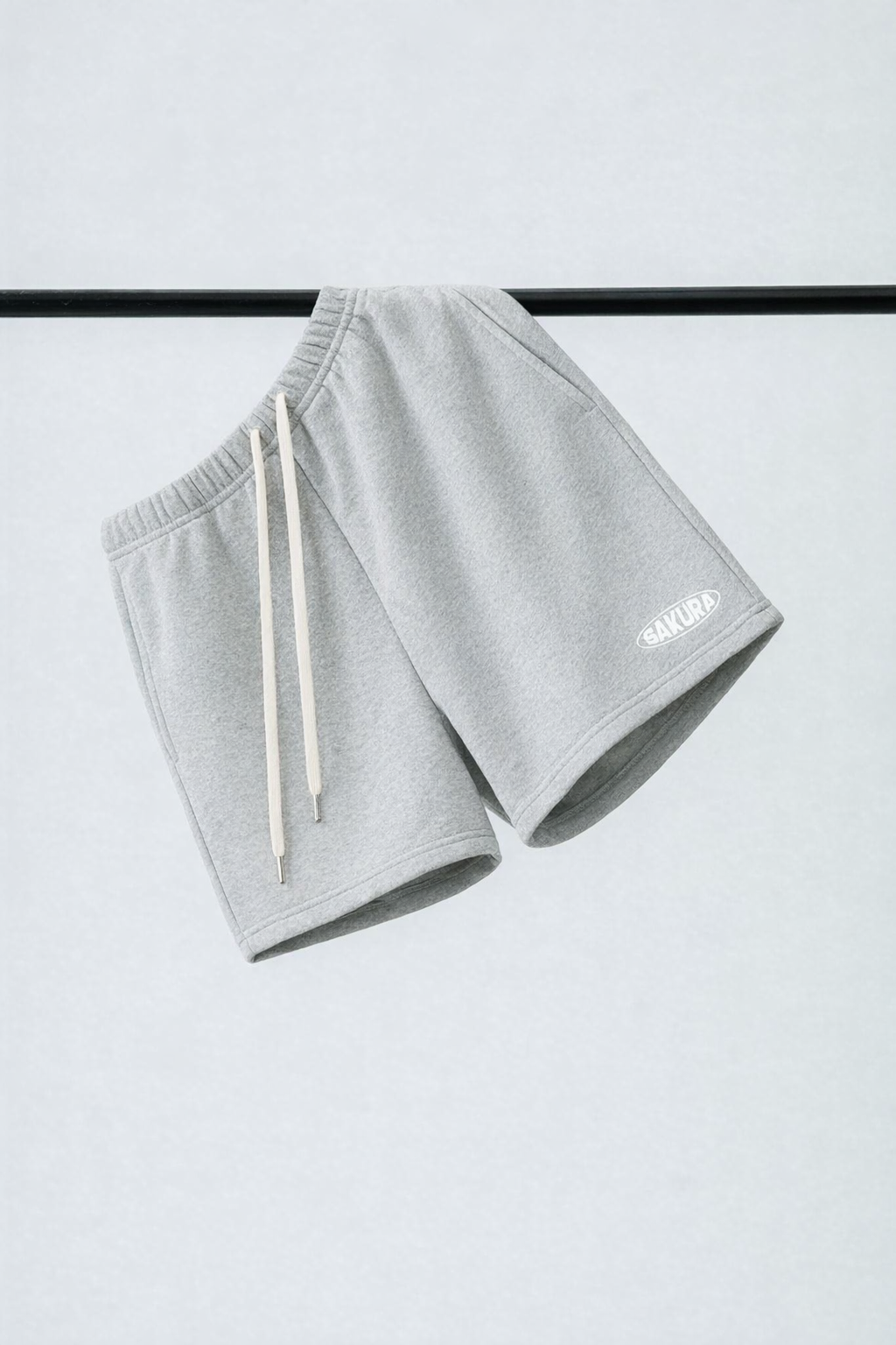 Gray shorts with white drawstrings on a light gray background